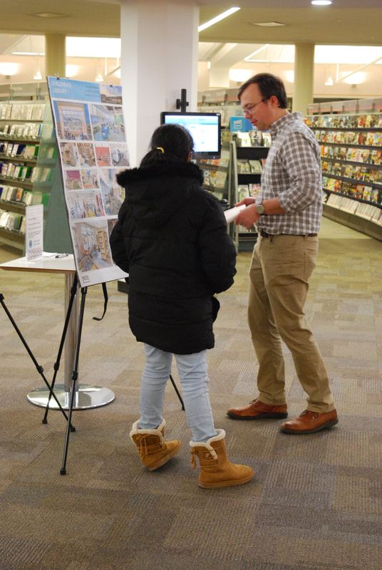 an architect chats with a young adult as they review an idea board full of photos