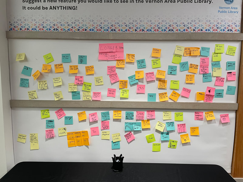 a wall of post-it notes with ideas for the library 